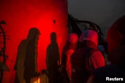 United Nations peacekeepers at the MINUSMA base take cover after a mortar attack in Kidal, Mali, June 8, 2017.