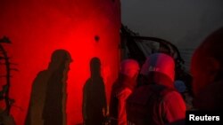 FILE - United Nations peacekeepers at the MINUSMA base take cover after a mortar attack in Kidal, Mali, June 8, 2017.