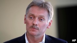 President Vladimir Putin's spokesman Dmitry Peskov speaks with The Associated Press in Moscow, April 6, 2017. Peskov, speaking days after a suspected chemical weapons attack, says Russia's support for Syrian President Bashar Assad is not unconditional.