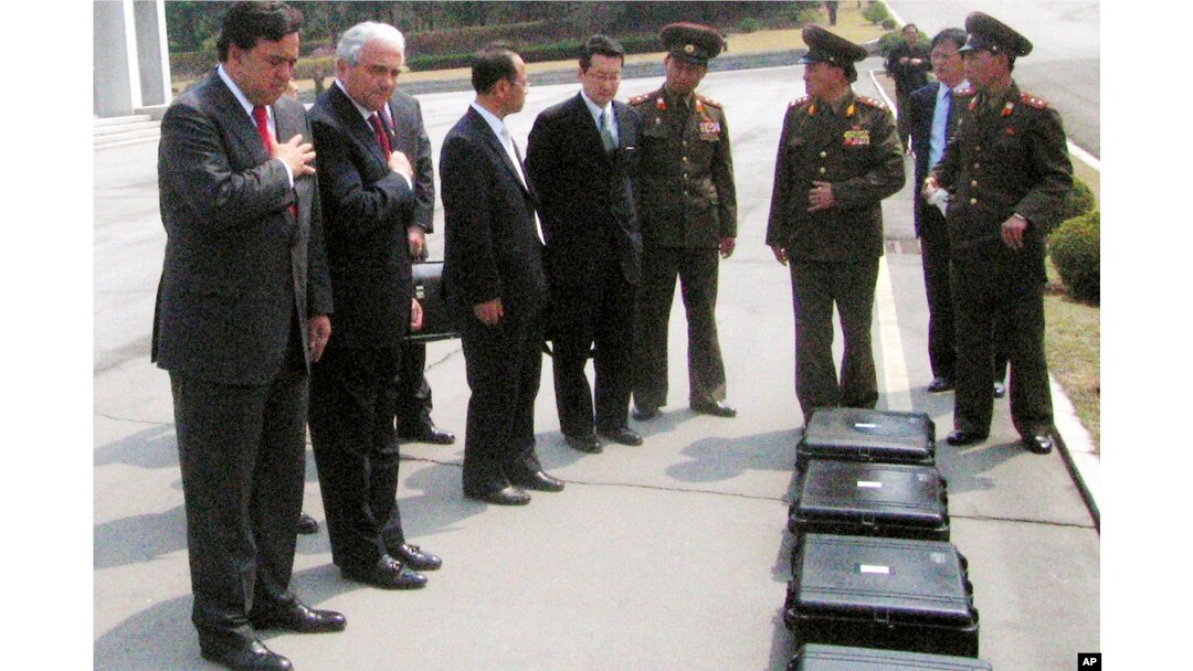 FILE - New Mexico Gov. Bill Richardson, left, pays respects to the remains of six American soldiers from the Korean War inside of black cases on North Korea's side of the border village of Panmunjom, April 11, 2007.