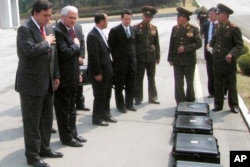 FILE - New Mexico Gov. Bill Richardson, left, pays respects to the remains of six American soldiers from the Korean War inside of black cases on North Korea's side of the border village of Panmunjom, April 11, 2007.