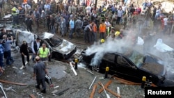 Soldiers, policemen and medical personnel gather at the site of explosions near the Iranian embassy in Beirut, Nov. 19, 2013.