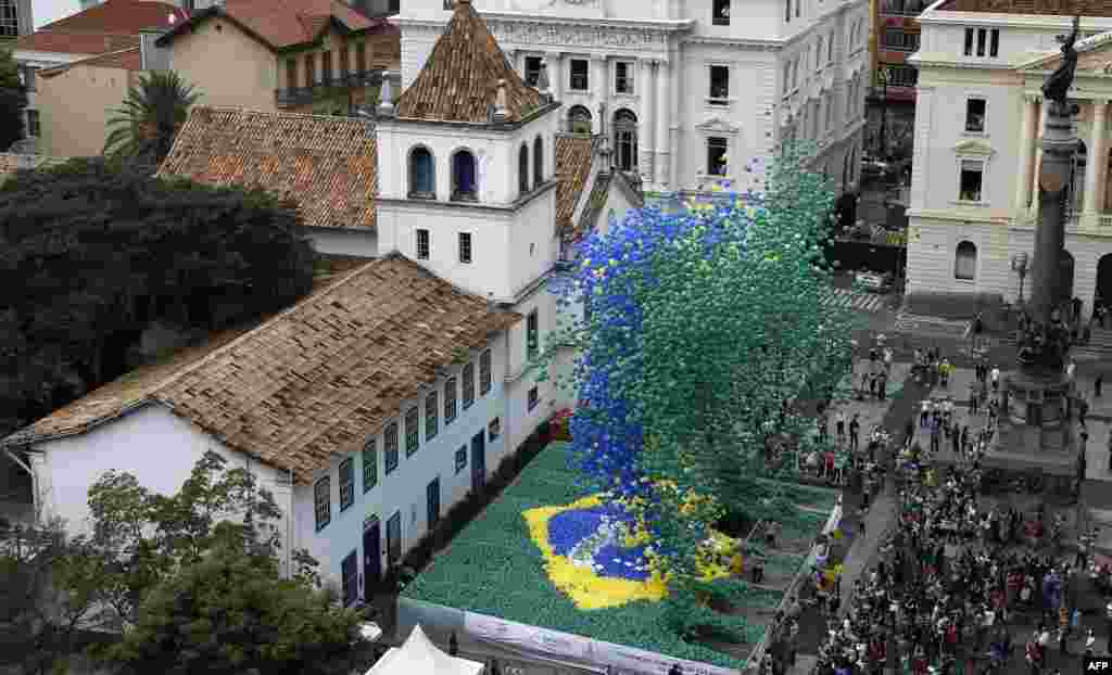 Thousands of biodegradable balloons in the colors of the Brazilian national flag are released by members of the Commercial Association as a New Year celebration in Sao Paulo, Brazil.