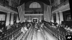 This is a 1924 photo of the immigration registry room at Ellis Island in New York Harbor.