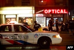 Police officers walk the scene at Danforth St. at the scene of a shooting incident, in Toronto, Canada, July 22, 2018.