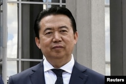 FILE - President Meng Hongwei poses during a visit to the headquarters of International Police Organisation in Lyon, France, May 8, 2018.