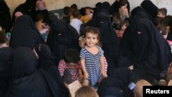 Families and relatives of Islamic State militants are seen after they surrendered themselves to the Kurdish Peshmerga forces in al-Ayadiya, northwest of Tal Afar, Iraq, Aug. 30, 2017.