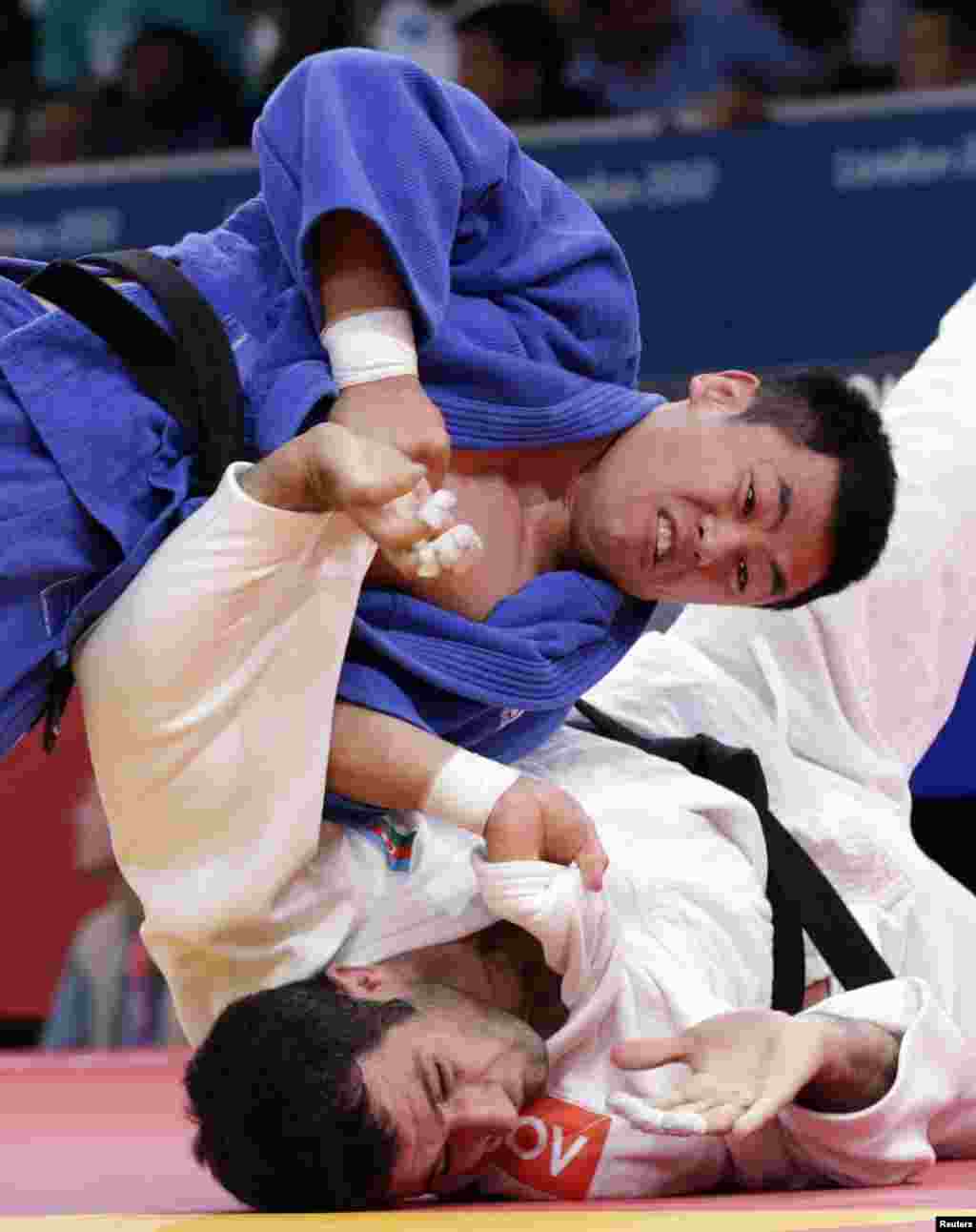 Azerbaijan's Elkhan Mammadov fights with South Korea's Song Dae-Nam (blue) during their men's -90kg elimination round of 16 judo match at the London 2012 Olympic Games August 1, 2012. REUTERS/Toru Hanai (BRITAIN - Tags: SPORT OLYMPICS SPORT JUDO)