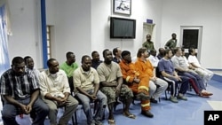 The 19 nineteen oil and construction workers taken hostage by Niger Delta militants and freed last week sit together in Port Harcourt, 18 Nov 2010