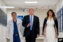 President Donald Trump, accompanied by first lady Melania Trump and Dr. Igor Nichiporenko, speaks to reporters while visiting with medical staff at Broward Health North in Pompano Beach, Fla., Feb. 16, 2018.