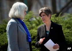 Sen. Joni Ernst, R-Iowa, right, speaks with Terry Harmon, daughter of WWII veteran WASP Elaine Harmon, left, before an event on the reinstatement of WWII female pilots at Arlington National Cemetery, on Capitol Hill in Washington, March 16, 2016.