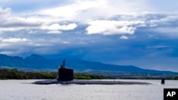 FILE - In this U.S. Navy photo, the Virginia-class fast-attack submarine USS Missouri departs Joint Base Pearl Harbor-Hickam, Sept. 1, 2021. Australia decided to invest in U.S. nuclear-powered submarines and dump its contract with France to build diesel-electric submarines because of a changed strategic environment.