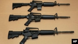 FILE -- Three variations of the AR-15 assault rifle are displayed in Sacramento, Calif. While the guns look similar, the bottom version is illegal in California because of its quick reload capabilities.