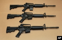FILE -- Three variations of the AR-15 assault rifle are displayed in Sacramento, Calif. While the guns look similar, the bottom version is illegal in California because of its quick reload capabilities. Omar Mateen used an AR-15 that he purchased legally
