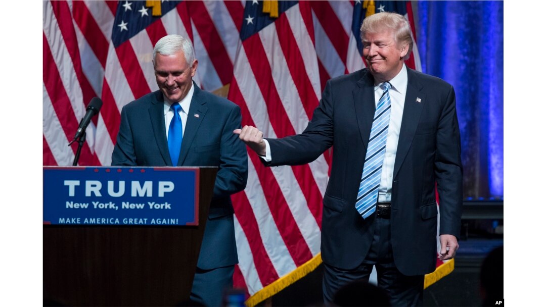 Republican presidential candidate Donald Trump, right, introduces Gov. Mike Pence, R-Ind., during a campaign event to announce Pence as the vice presidential running mate on, Saturday, July 16, 2016, in New York.