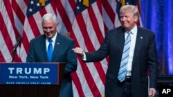 Republican presidential candidate Donald Trump, right, introduces Gov. Mike Pence, R-Ind., during a campaign event to announce Pence as the vice presidential running mate on, Saturday, July 16, 2016, in New York. 