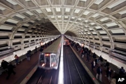 FILE - Metro trains arrive in the Gallery Place-Chinatown Metro Station in Washington, March 15, 2016.