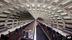 FILE - Metro trains arrive in the Gallery Place-Chinatown Metro station in Washington, March 15, 2016. The entire system was shut down for a day for emergency maintenance last month.