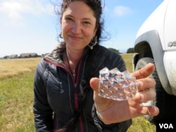 "This is one of the things I think is the coolest," said project archaeologist Chelsea Rose of this shard of sawtooth leaded glass, one of thousands of artifacts unearthed at Miner's Fort. (Tom Banse for VOA)