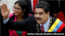 FILE - Venezuelan President Nicolas Maduro greets the National Constituent Assembly and its leader, Delcy Rodriguez, in Caracas, Jan. 15. Maduro says he will seek re-election. 