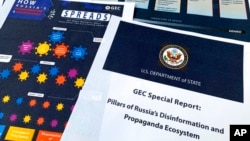 FILE - Pages from the U.S. State Department's Global Engagement Center report released on Aug. 5, 2020, are seen in this photo.