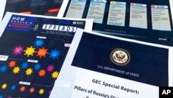 FILE - Pages from the U.S. State Department's Global Engagement Center report, released Aug. 5, 2020, are pictured. The State Department said Russia was using an online operation to stir up confusion around the coronavirus by amplifying conspiracy theories and misinformation.