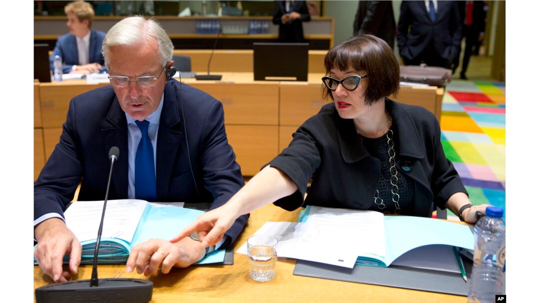 European Union chief Brexit negotiator Michel Barnier, left, speaks with EU Deputy Chief Negotiator Sabine Weyand during a meeting of EU General Affairs, Article 50, ministers in Brussels on Sept. 25, 2017.