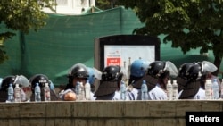 Police guard the entrance of Albania's Central Election Commission during a protest, Tirana, May 21, 2011.