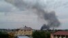 FILE - Black smoke is seen rising above the capital Juba, in South Sudan, July 10, 2016. 