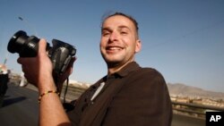 FILE - Luke Somers, 33, an American photojournalist who was kidnapped over a year ago by al-Qaida, poses for a picture during a parade marking the second anniversary of the revolution in Sanaa, Yemen.