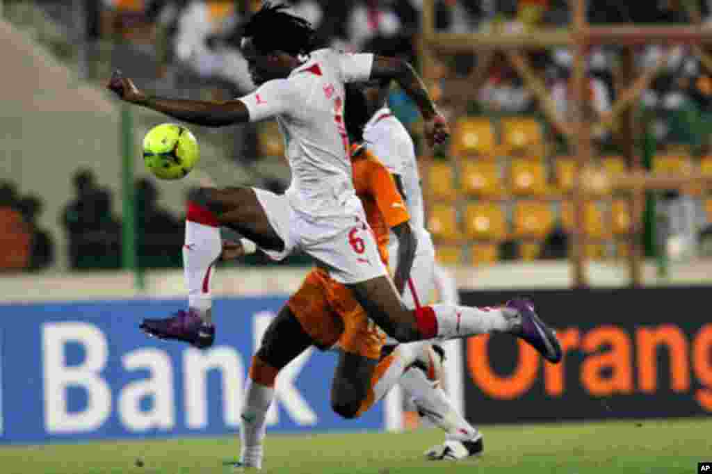 Kone of Burkina Faso fights for the ball with Gervinho of Ivory Coast during their African Nations Cup soccer match in Malabo