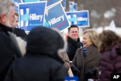 Democratic presidential candidate Hillary Clinton campaigns outside a polling place during the first-in-the-nation presidential primary, in Nashua, N.H., Feb. 9, 2016.