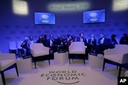 Attendees wait for the start of a session at the annual meeting of the World Economic Forum in Davos, Switzerland, Jan. 22, 2019.
