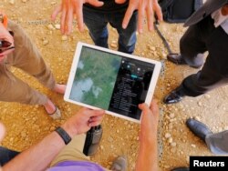 A Zipline engineer monitors a drone's flight on a tablet at an operations base in Muhanga, south of Rwanda's capital, Kigali, Oct. 12, 2016.