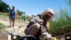 Workers in Afghanistan are seen removing land mines left from previous conflicts.