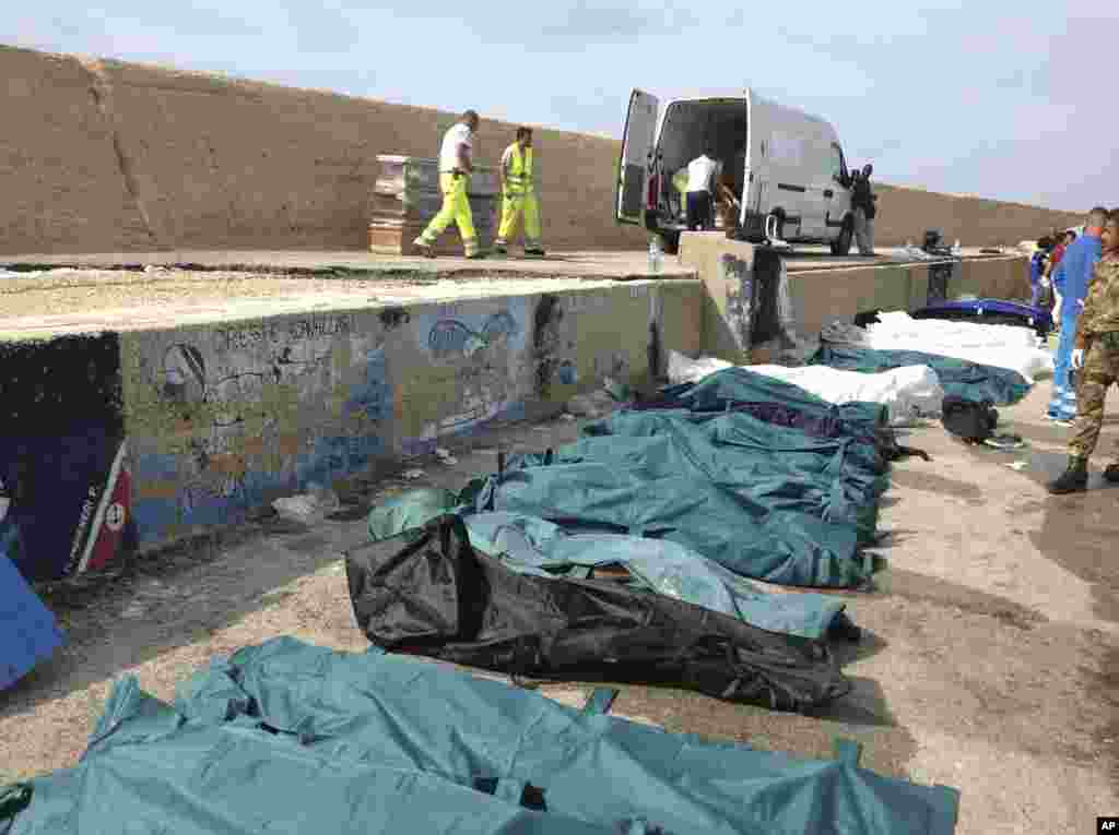 Bodies of drowned migrants are lined up in the port of Lampedusa, Italy, Oct. 3, 2013. 