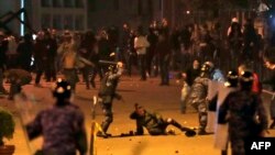 FILE - Lebanese riot police clash with anti-government demonstrators in the capital Beirut on Dec. 14, 2019. 