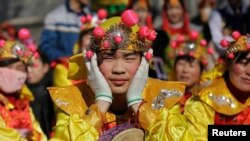 Performers wait for their turn to go onto the stage at the Longtan park as the Chinese Lunar New Year, which welcomes the Year of the Monkey, is celebrated in Beijing, China, Feb. 9, 2016. 