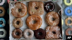 In this Jan. 12, 2007 file photo, a box of transfat-free donuts sit in the front window of the shop on New York's Lower East Side. (AP Photo/Richard Drew, File)