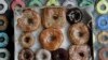 File- In this Jan. 12, 2007 file photo, a box with a variety of doughnuts from Doughnut Plant sit in the front window of the shop on New York's Lower East Side. (AP Photo/Richard Drew, File)