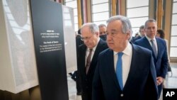 Antonio Guterres, United Nations Secretary-General, center, walks along the Yad Vashem Book of Names of Holocaust Victims Exhibit, Jan. 26, 2023, at United Nations headquarters in New York. 