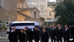Prince Philippos, left, Prince Pavlos, center, and &nbsp;Prince Nikolaos, right, sons of former king of Greece Constantine II, walk behind their father coffin as they arrive at the Metropolitan cathedral for his funeral in Athens.&nbsp;