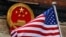 FILE - A U.S. flag flies next to the Chinese national emblem during a welcome ceremony at the Great Hall of the People in Beijing, Nov. 9, 2017. U.S. Secretary of State Antony Blinken is expected to visit Beijing in coming weeks.