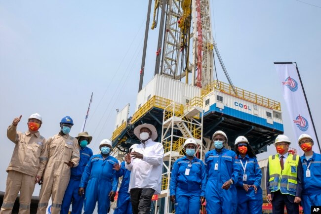 Chinese workers from China Oilfield Services Limited (COSL) begin drilling at the Kingfisher oil field on the shores of Lake Albert in the Kikuube district of western Uganda Tuesday, Jan. 24, 2023. (AP Photo/Hajarah Nalwadda)