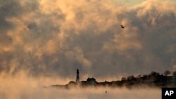 Arctic sea smoke rises from the Atlantic Ocean at Portland Head Light, Feb. 4, 2023, in Cape Elizabeth, Maine. The morning temperature was about -10 degrees Fahrenheit.