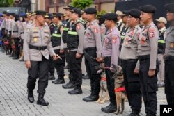Komisaris Jenderal Badan Pemeliharaan Polri, Arief Sulistyanto (kiri), memeriksa petugas medis polisi dan petugas tim K-9 yang bersiap melakukan perjalanan ke Turki untuk berpartisipasi dalam operasi pencarian dan penyelamatan di Jakarta, Kamis, 9 Februari 2023. (AP/Achmad Ibrahim)