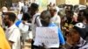 Sudanese anti-coup protesters march down a street in Khartoum, Feb. 8, 2023 