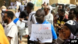 Sudanese anti-coup protesters march down a street in Khartoum, Feb. 8, 2023 