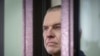FILE - Journalist Andrzej Poczobut stands in a defendants' cage during a court session in Grodno, Belarus, Jan. 16, 2023. 