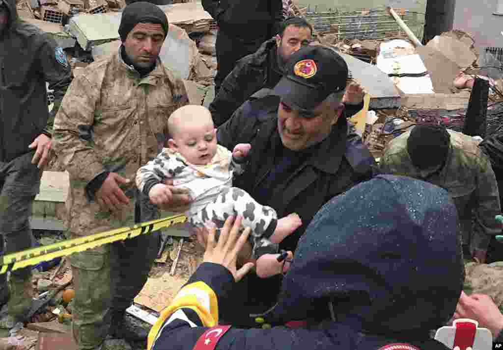 A baby is rescued from a destroyed building in Malatya, Turkey, Feb. 6, 2023. (DIA Images via AP)